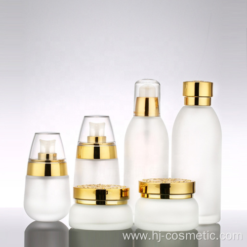 wholesales High-grade golden carved ABS cap transparent glass cosmetic bottles/jars with good price